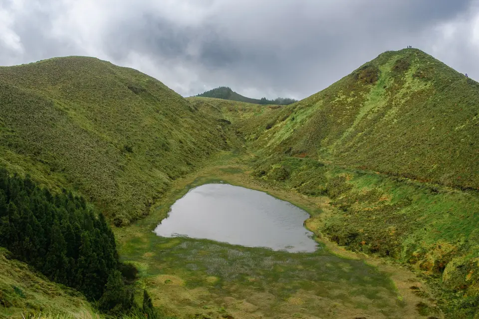 Lush green landscape with crater lake and mountains on Sao Miguel Island, Azores.