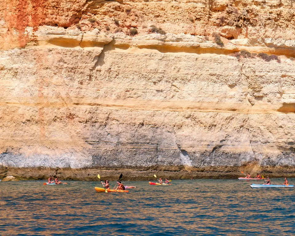 Experience kayaking against the stunning Algarve cliffs in Portugal's beautiful coastline.