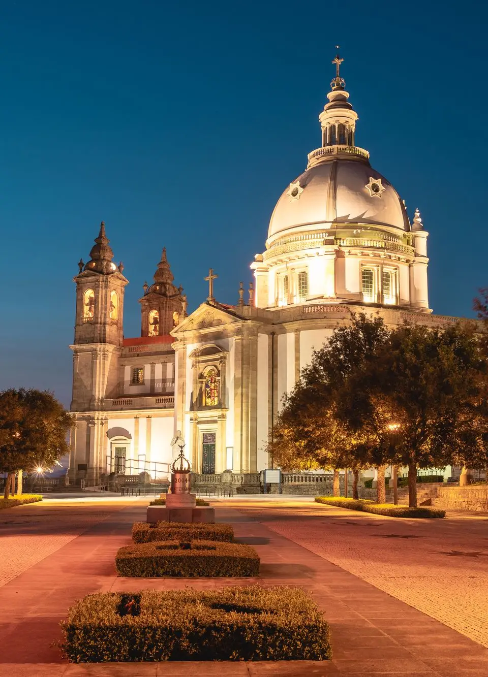 The illuminated Sanctuary of Our Lady of Sameiro in Braga, Portugal during twilight, showcasing stunning architecture.