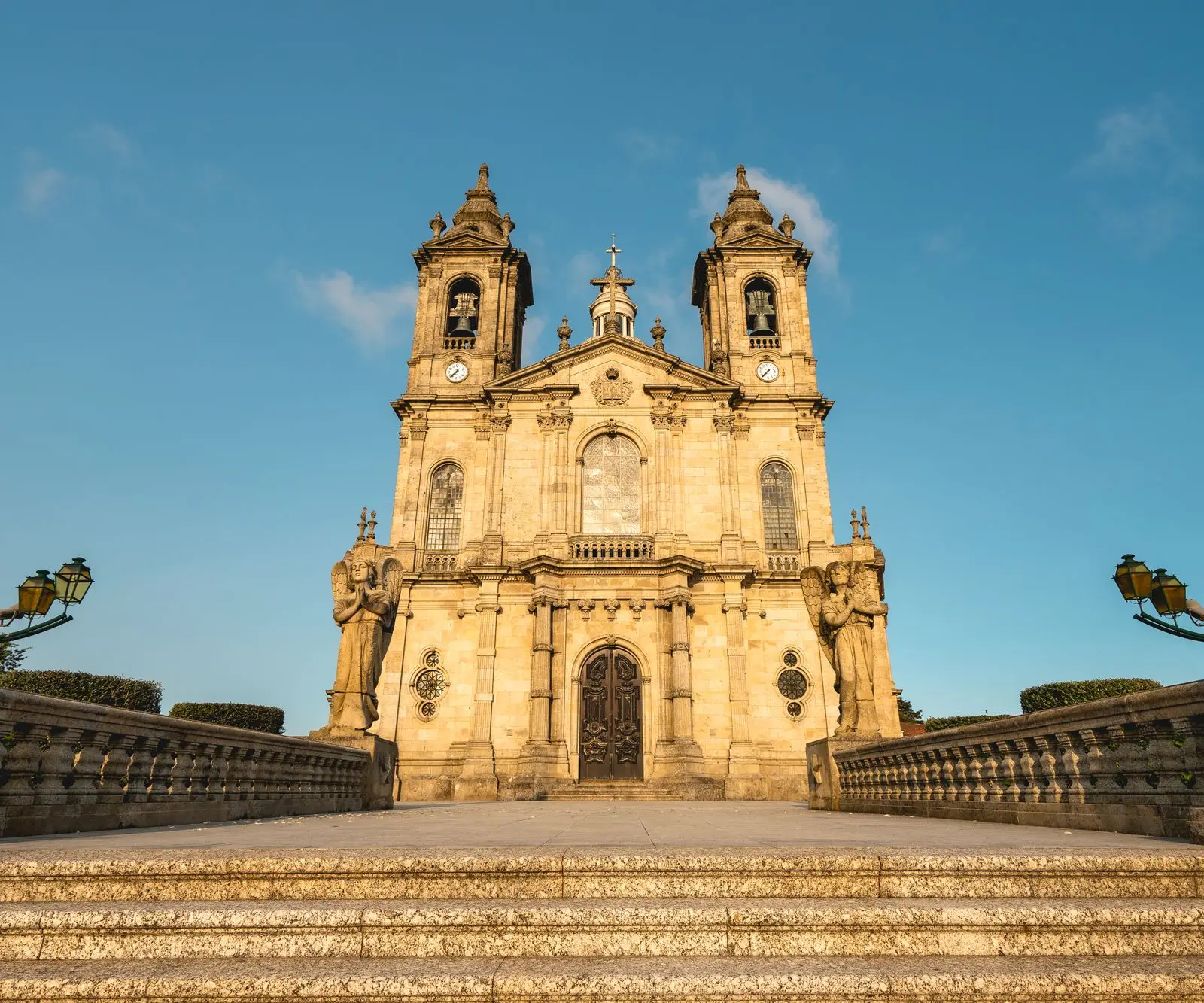 Majestic view of the Sanctuary of Bom Jesus do Monte with its architectural brilliance under a clear blue sky in Braga, Portugal.