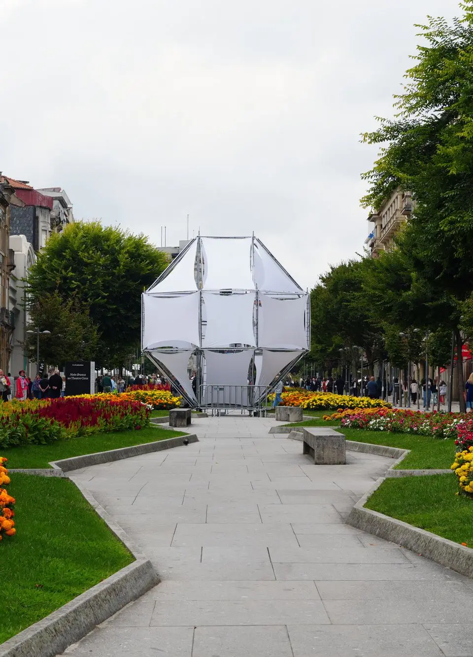 A vibrant urban park in Braga, Portugal showcasing colorful flowers and modern architecture.