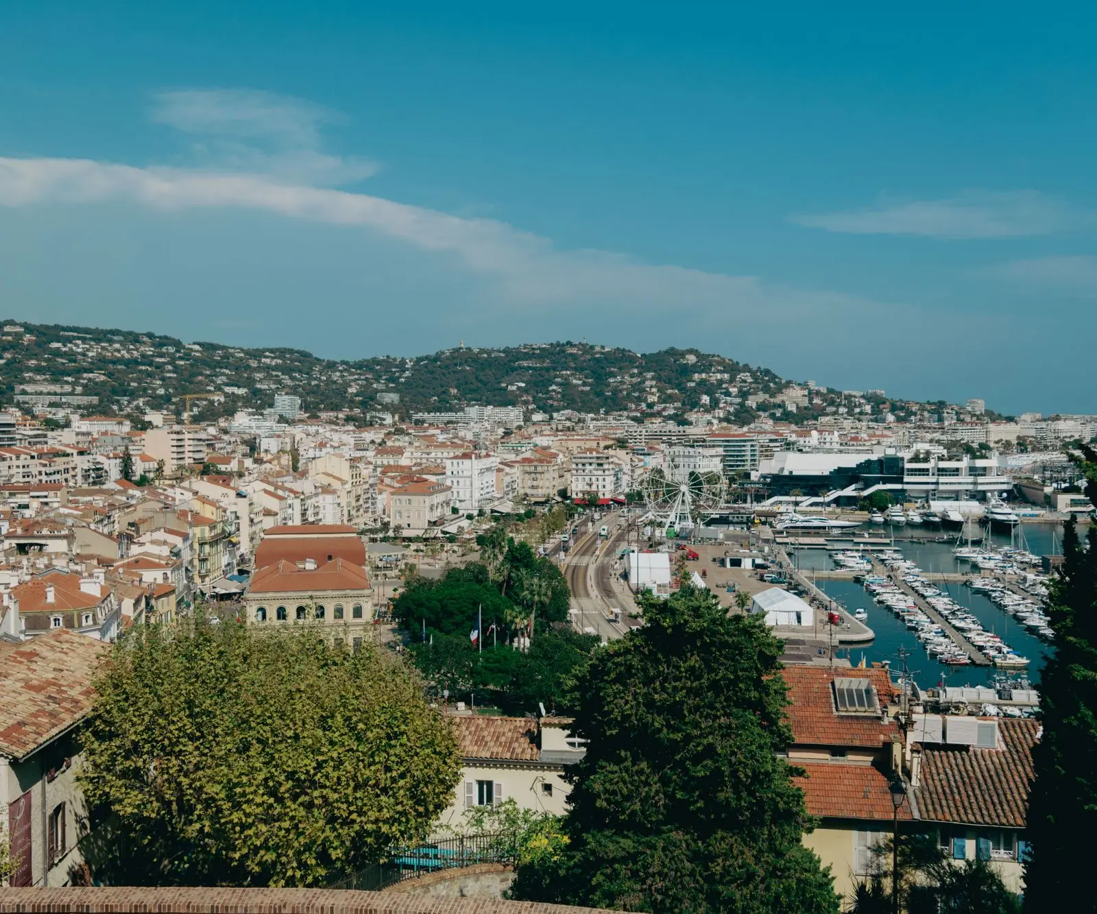 A stunning view of Cannes showcasing the harbor, cityscape, and Mediterranean coast.