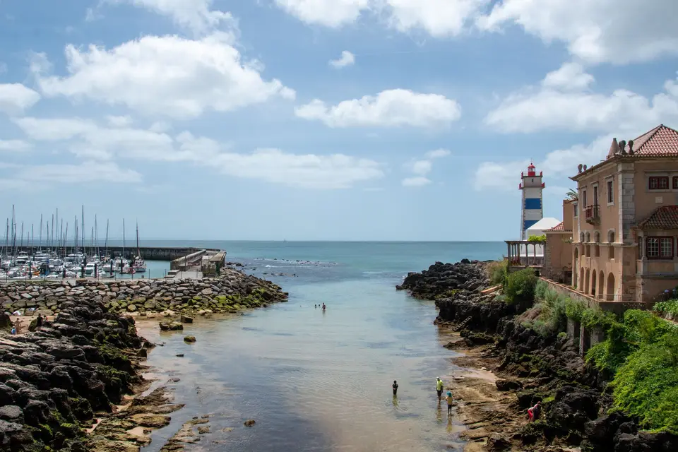 A beautiful summer day at Cascais marina with a view of Santa Marta Lighthouse, Portugal.