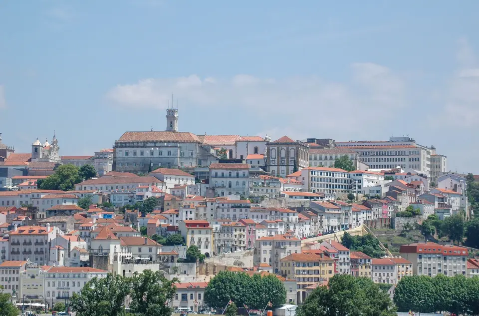Panoramic view of Coimbra's historic cityscape with iconic architecture on a sunny day.
