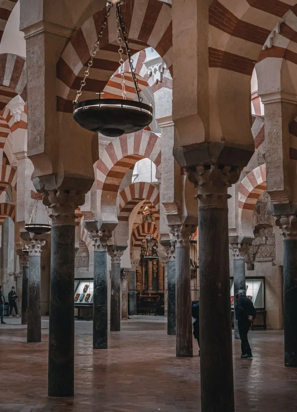 Explore the historic Mosque-Cathedral of Córdoba's stunning arches and columns in this captivating interior view.