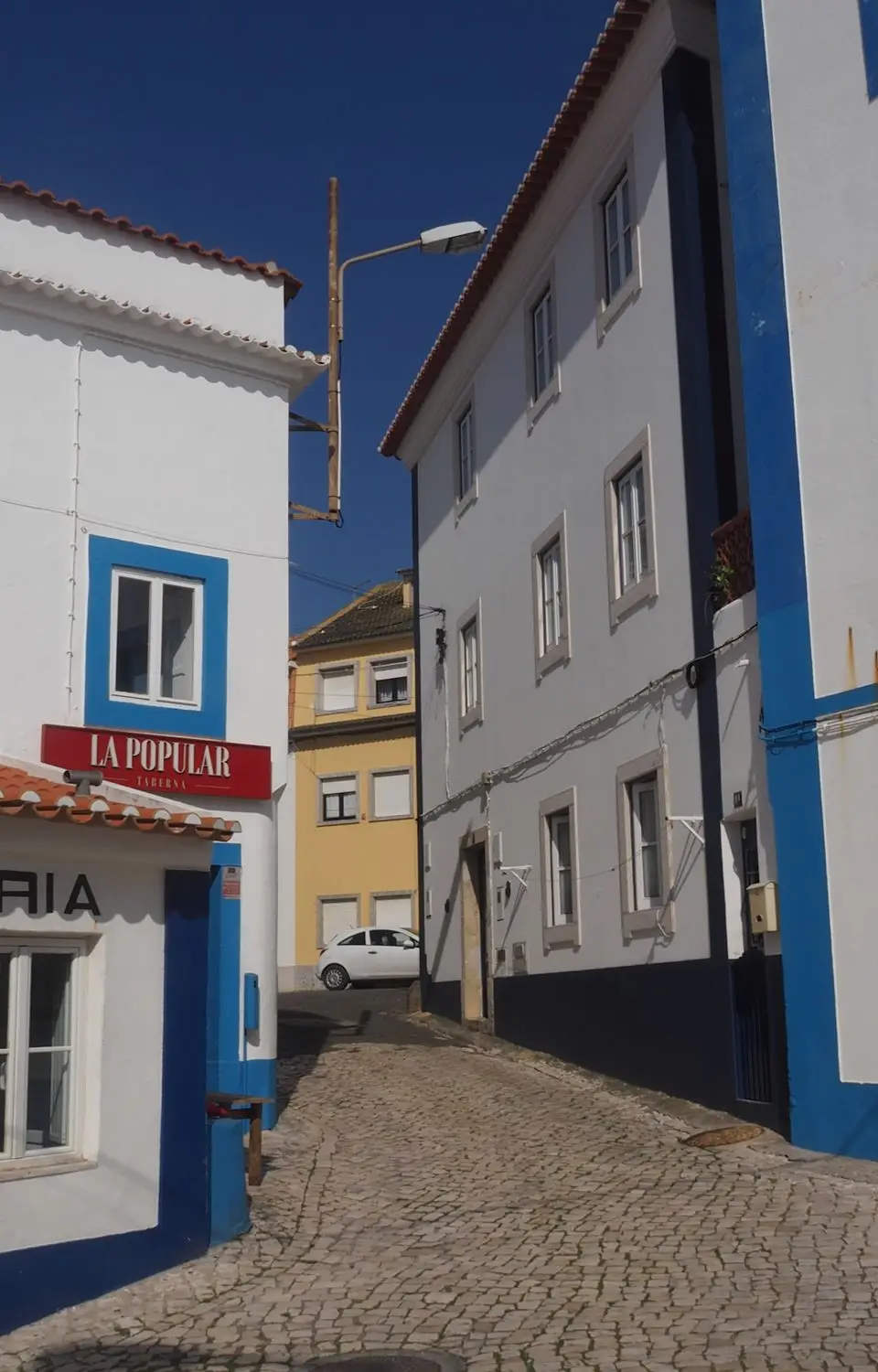 Historic street in Ericeira, Portugal, showcasing traditional Portuguese architecture.