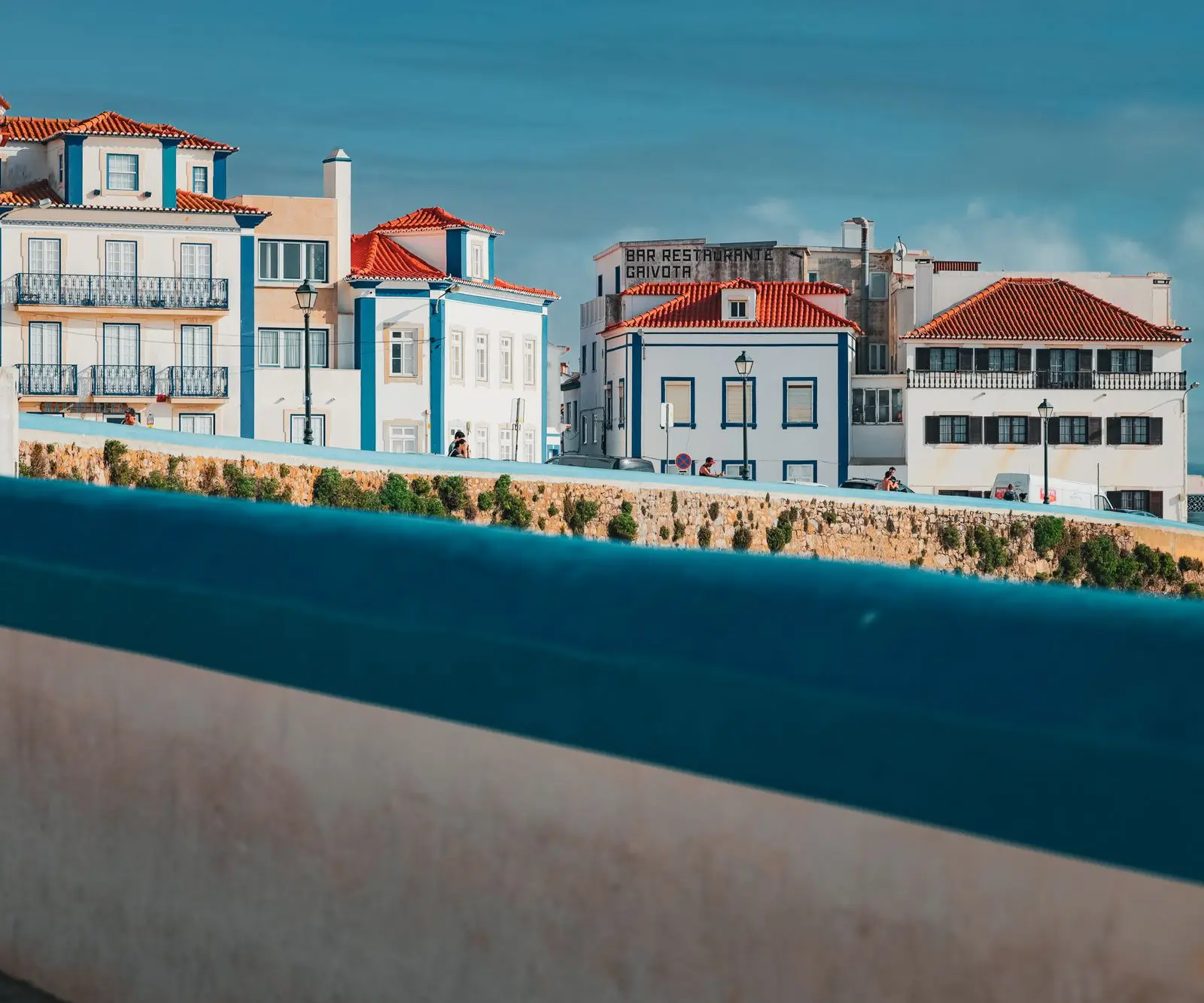 Captivating coastal architecture in Ericeira, Lisbon, showcasing colorful facades and vibrant rooftops.