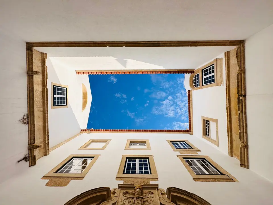 Discover the historic architecture of Tomar, Portugal, through this captivating courtyard view.