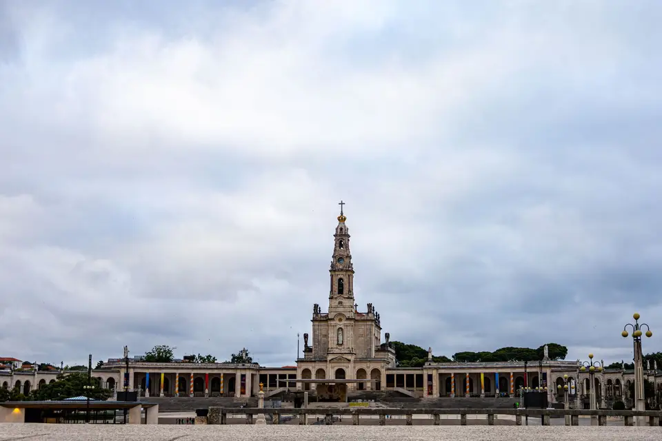 The Sanctuary of Fátima in Portugal captured with cloudy skies, highlighting its iconic architecture.