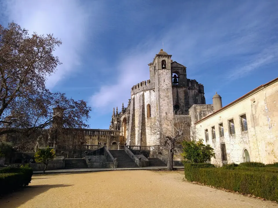 Majestic Tomar Castle in Portugal under a vibrant blue sky, showcasing historical architecture.