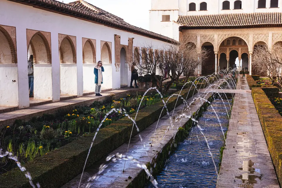 Captivating view of Alhambra's intricate architecture and lush gardens in Granada.