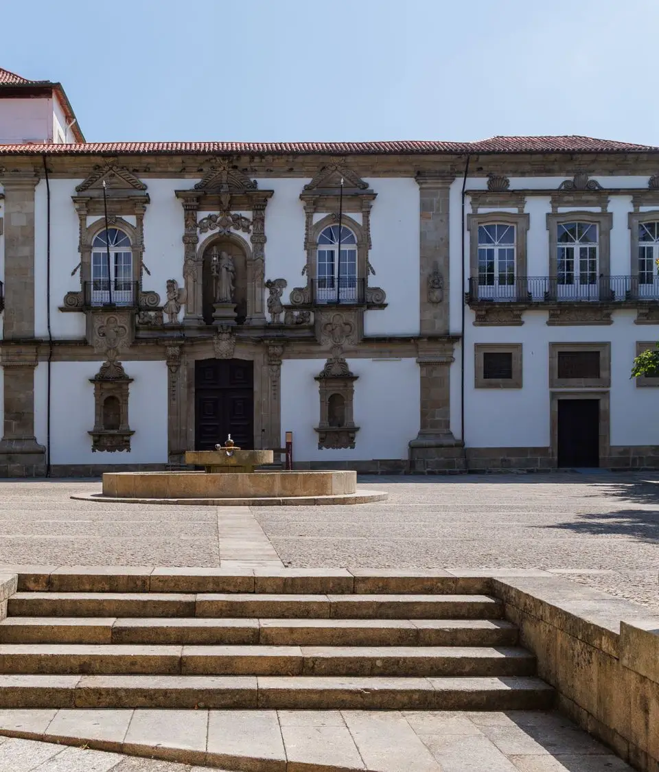 A beautiful sunny day at a historic town square in Guimaraes, Portugal, showcasing stunning architecture.