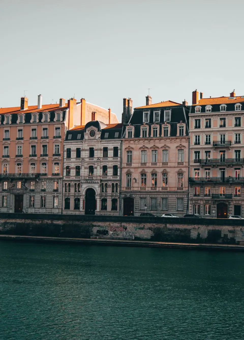 Charming view of historic buildings lining the Rhône River in Lyon, France.