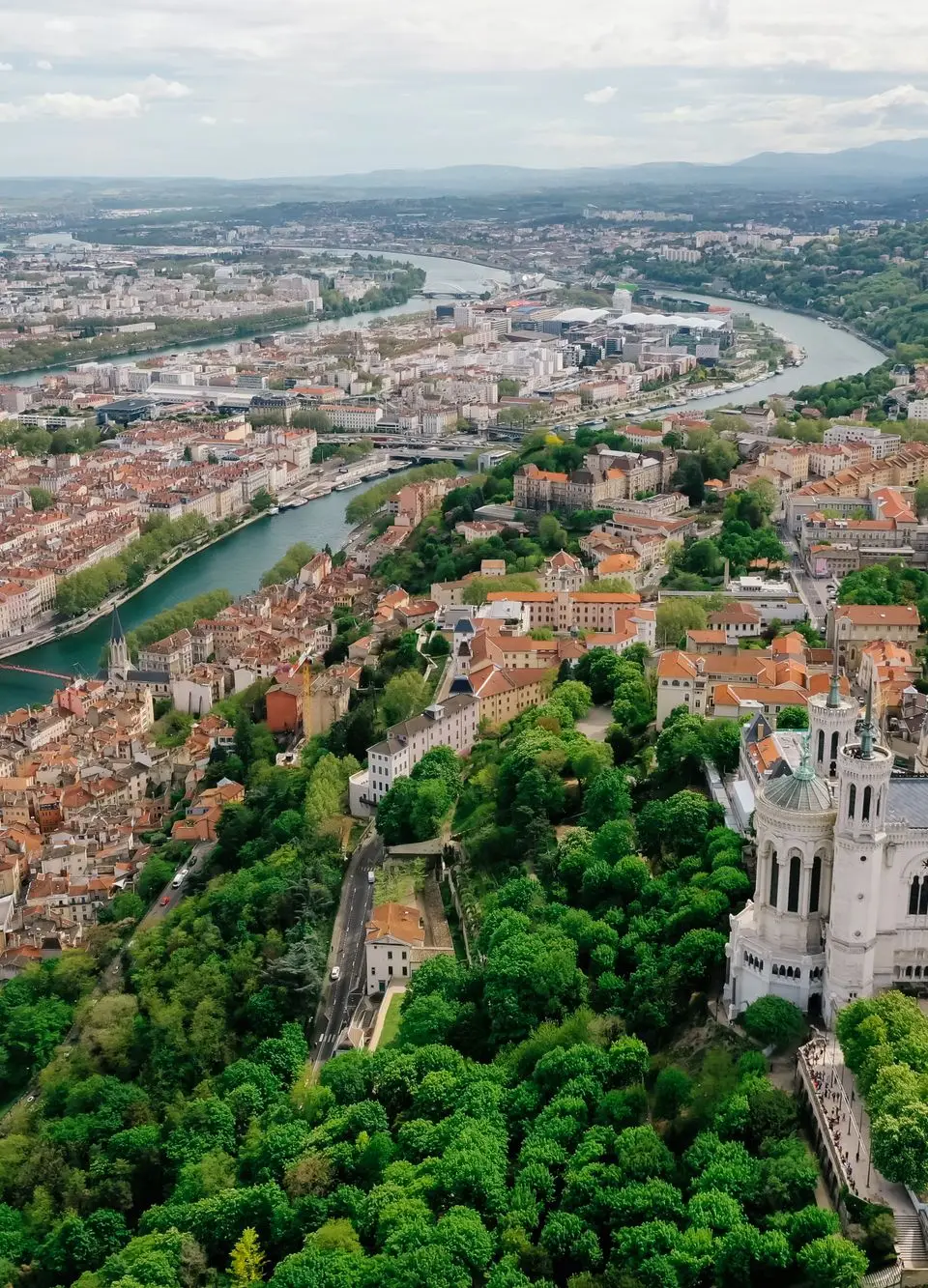 A stunning aerial view of Lyon showcasing the Basilica of Notre Dame and the city's vibrant landscape.