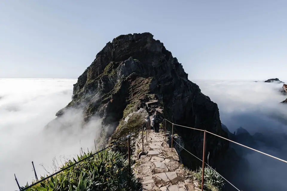 Breathtaking hike along a misty mountain peak in Madeira, Portugal.