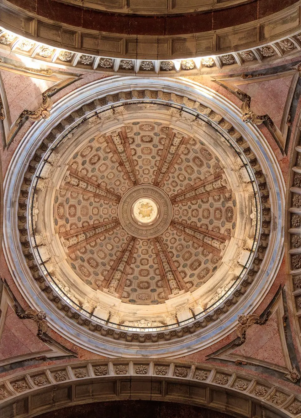 Detailed view of the intricate baroque architecture of the dome in Mafra Palace, Portugal.