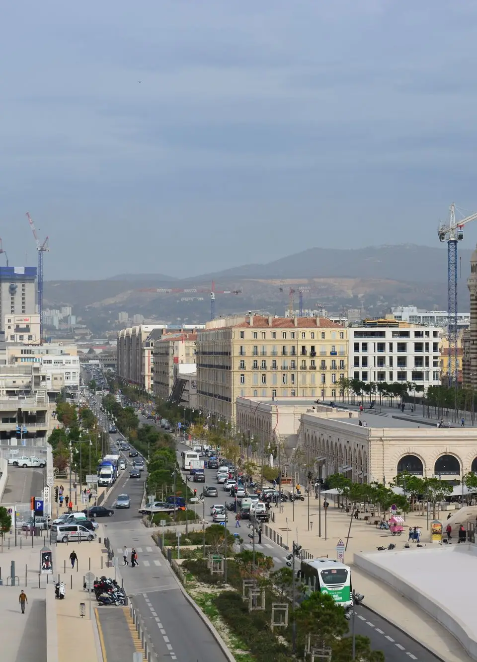 A bustling urban scene in Marseille featuring the iconic cathedral and busy streets.