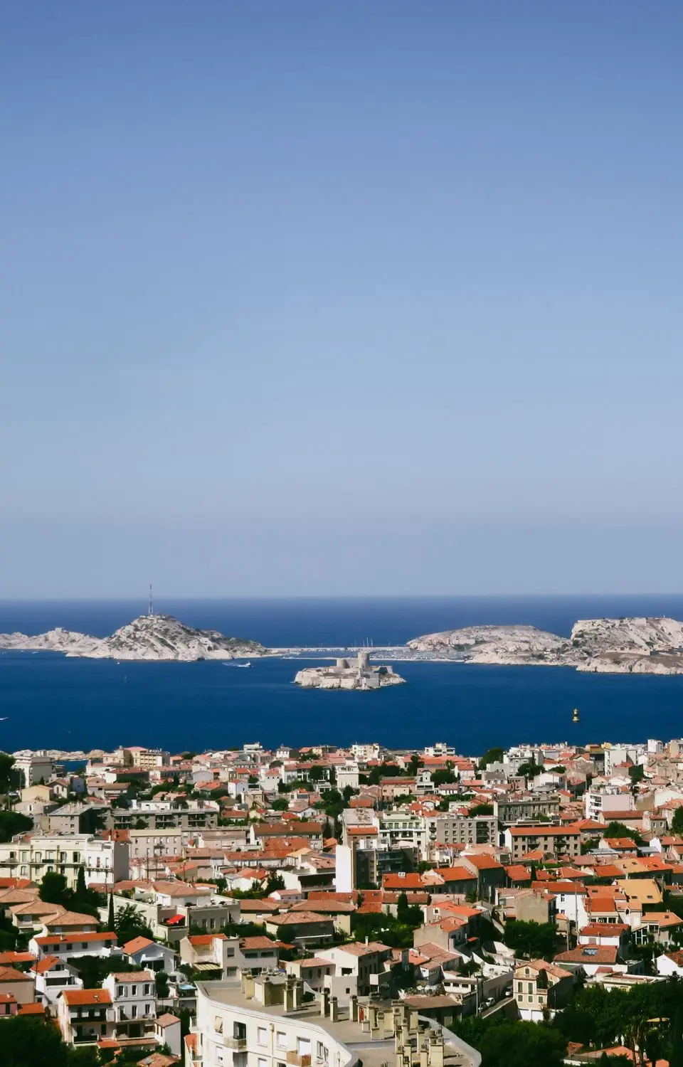 Stunning aerial view of Marseille's coast with the Frioul Archipelago under clear blue skies.