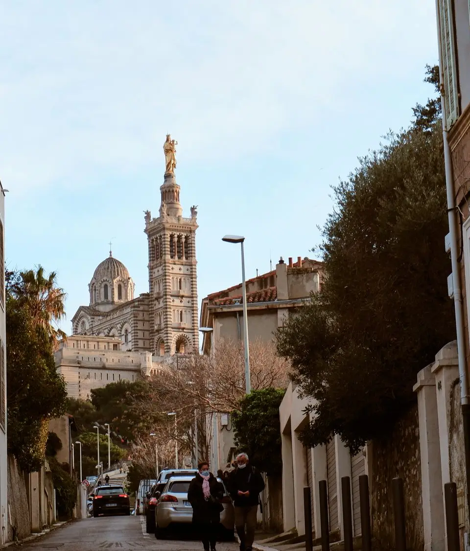 Captivating street scene with Notre-Dame de la Garde in Marseille, France, showcasing historical architecture.