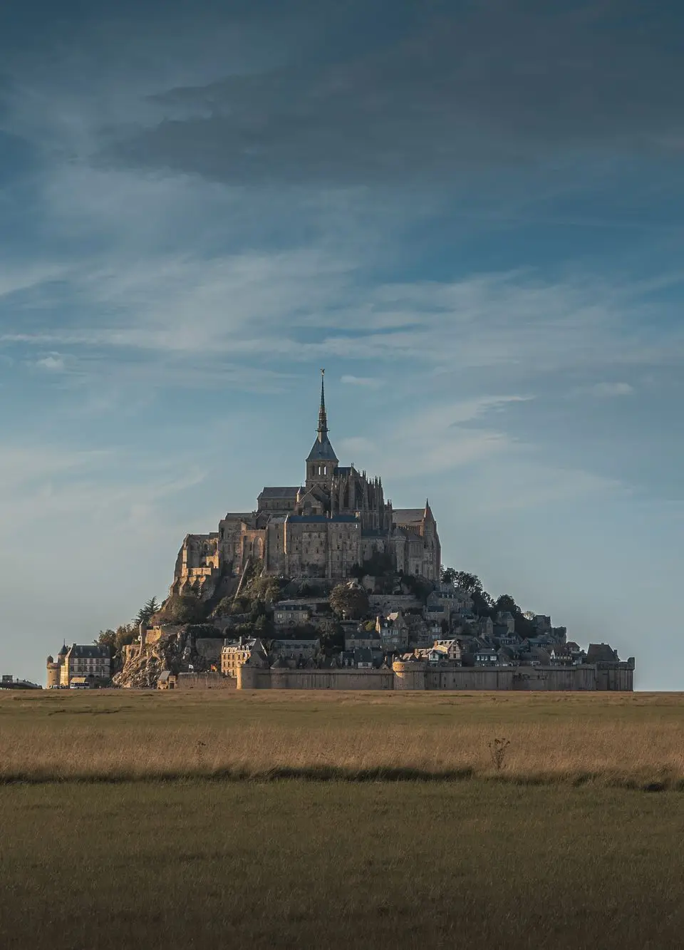 Breathtaking view of Mont Saint-Michel Abbey in Normandy at dusk.