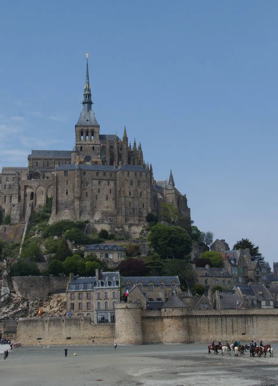 Explore the architectural beauty of Mont Saint-Michel Abbey in France on a clear day.