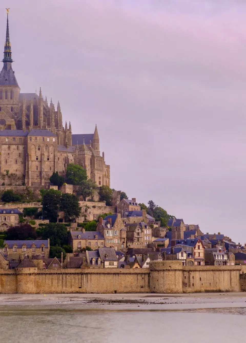 Explore the stunning architecture of Mont Saint-Michel in Normandy, France, captured in a serene setting.