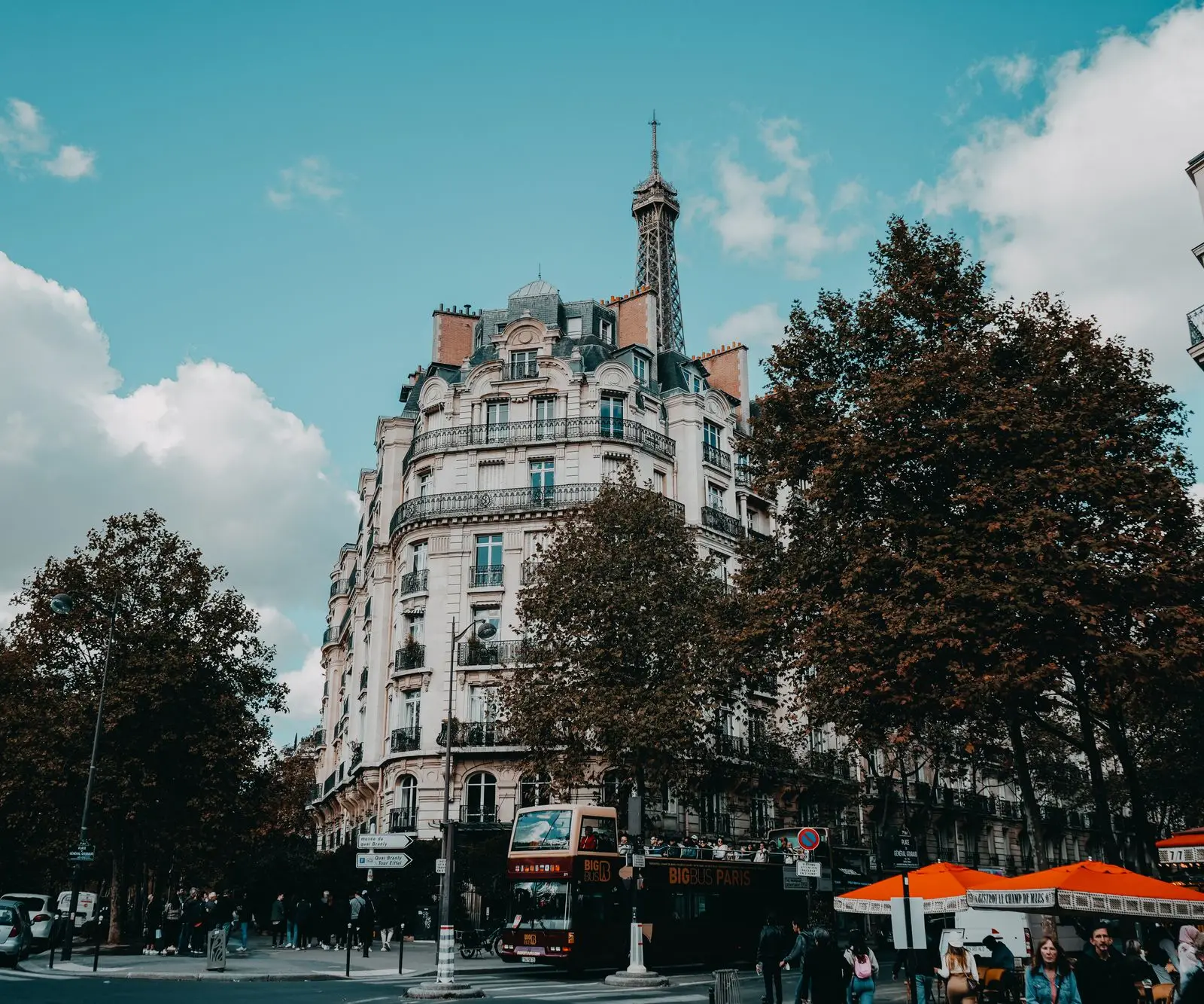 Charming urban street scene in Paris with classic architecture and the Eiffel Tower.
