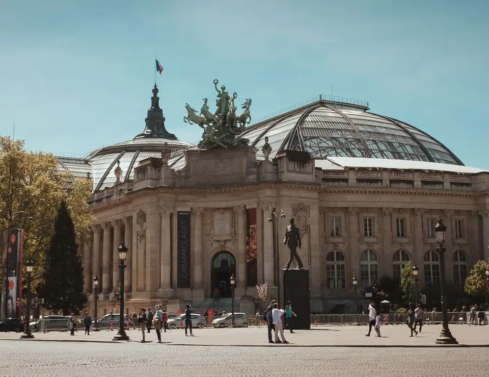 A captivating view of the Grand Palais in Paris, showcasing its iconic architecture under a clear blue sky.