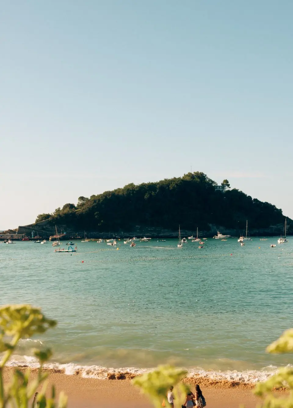 Beautiful summer beach scene with views of Isla de Santa Clara, San Sebastian, Spain.