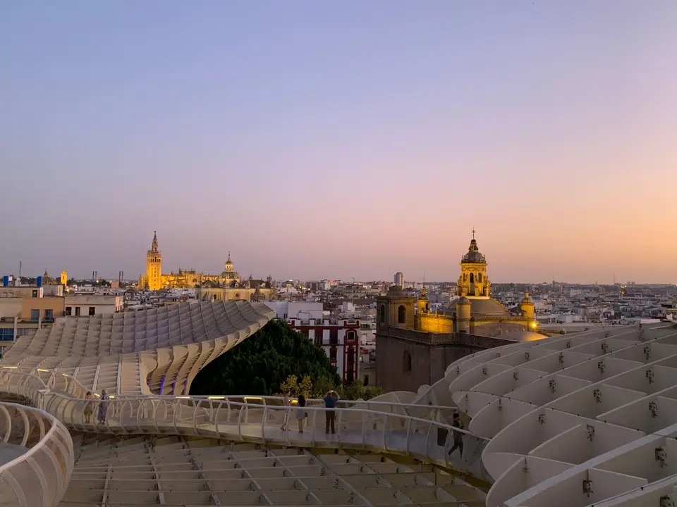 Stunning sunset view of Seville with Metropol Parasol and cathedral in the skyline.