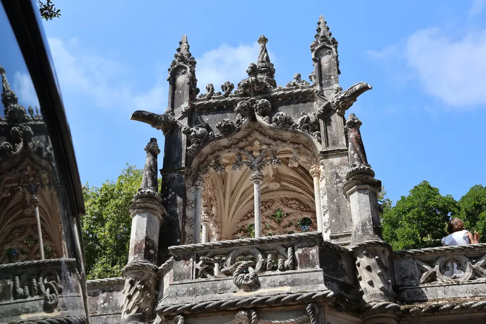 Intricate Gothic-style architecture of Quinta da Regaleira under a clear blue sky.