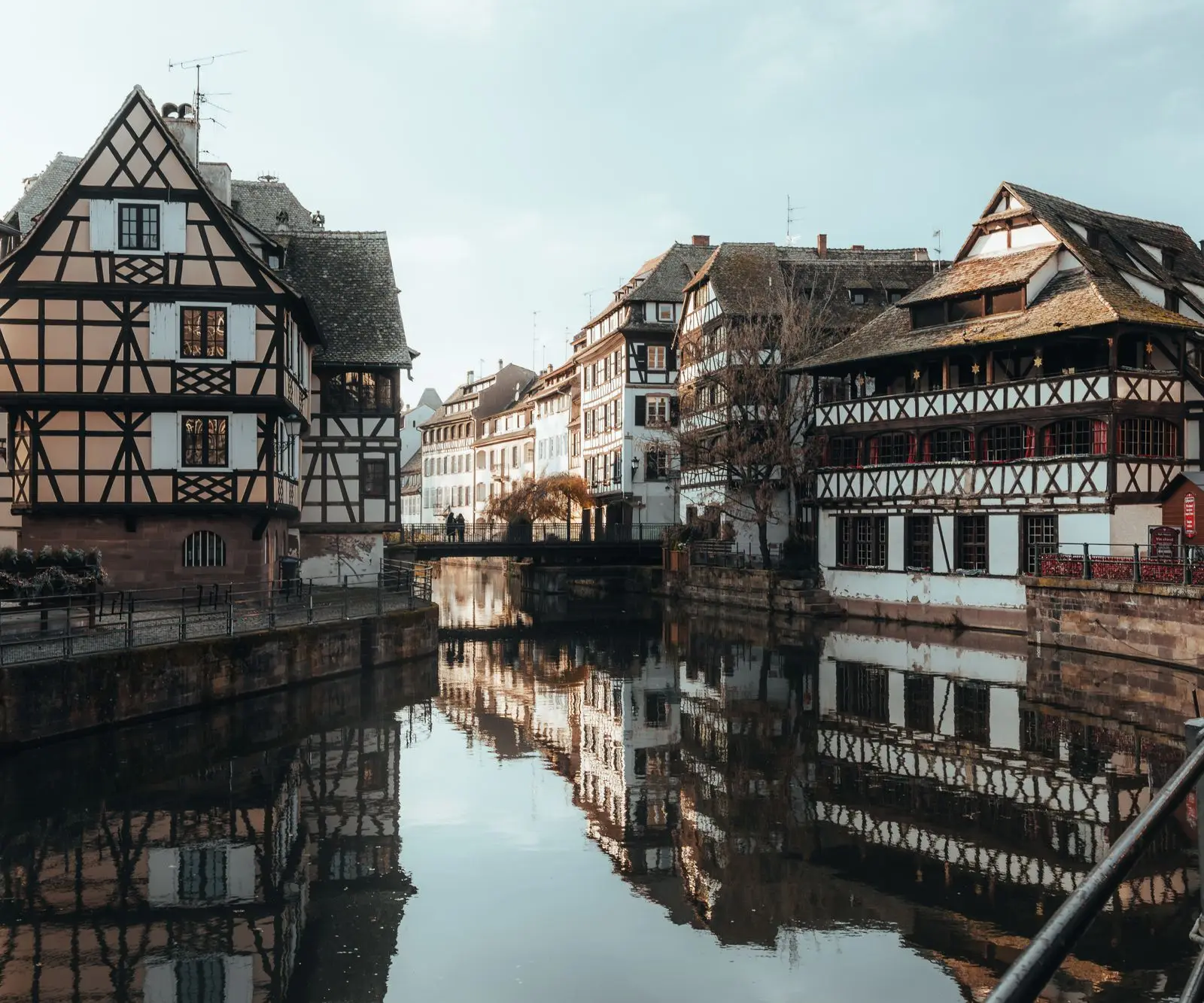 Picturesque view of half-timbered houses reflected in a canal, Strasbourg, France.