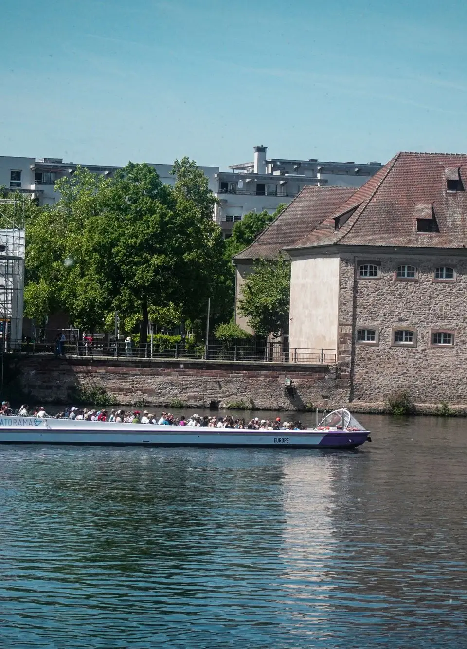 Explore the charming canals in Strasbourg, France with a scenic boat tour on a sunny day.