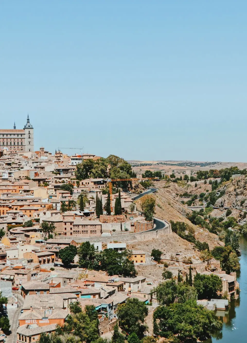 Discover Toledo, Spain's stunning view with historic architecture and the Tagus River flowing nearby.