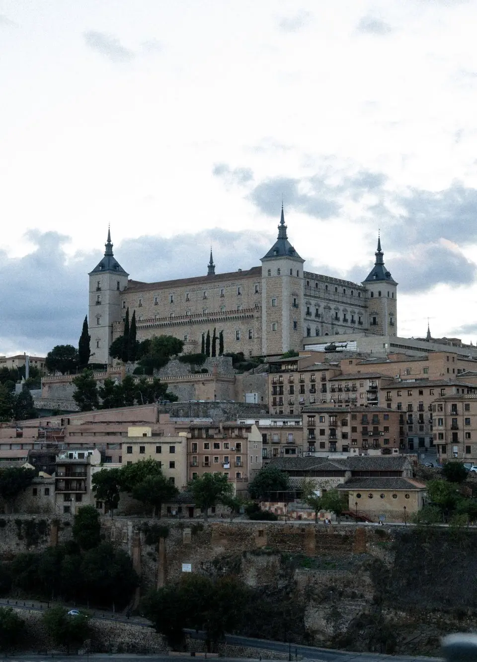 Majestic Alcázar de Toledo with a historical skyline at dusk, Spain.
