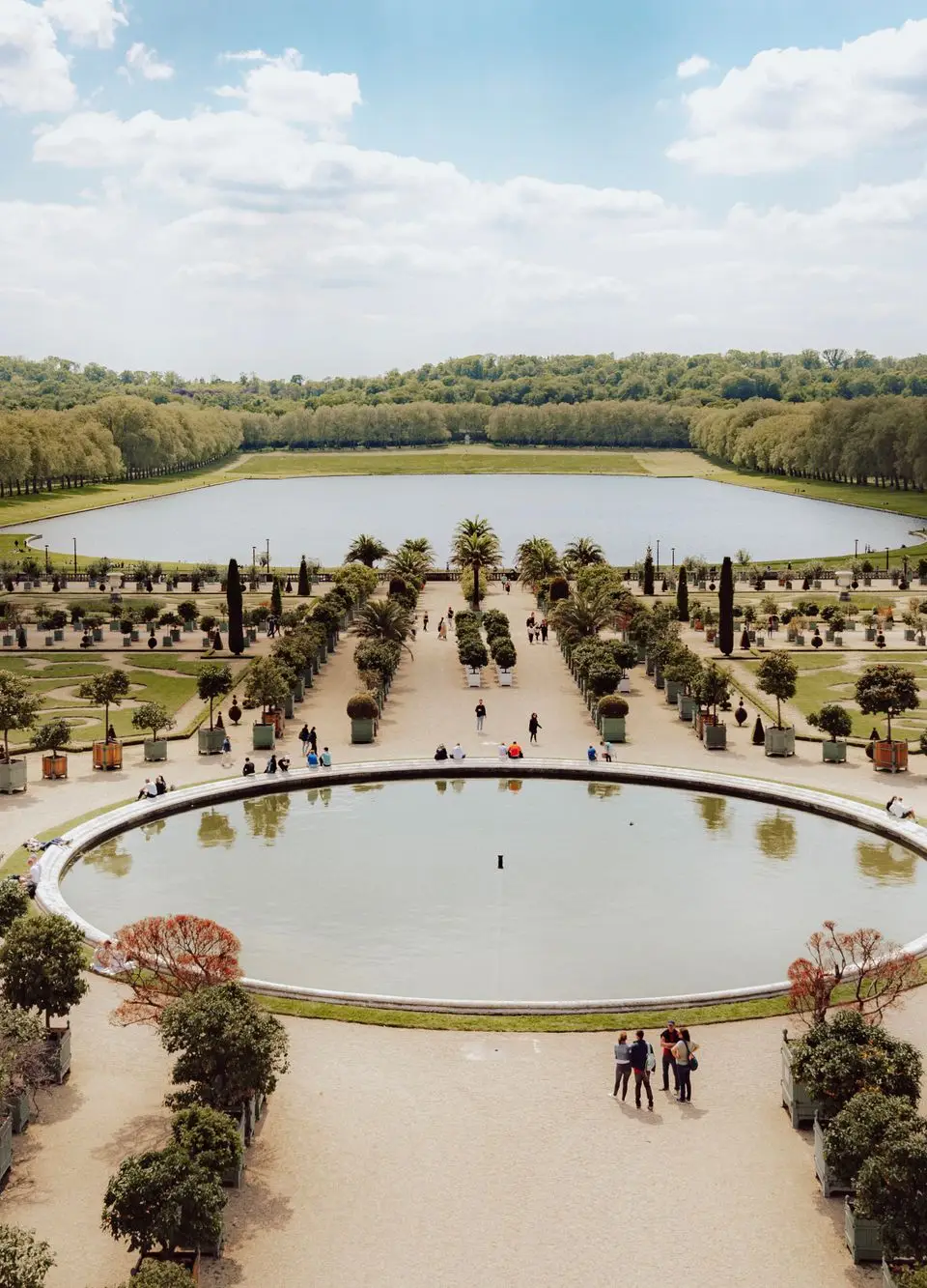 Stunning aerial view of Versailles gardens and ponds on a sunny day.